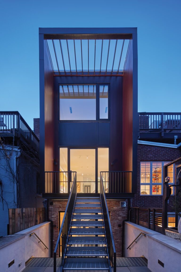 A Logan Circle project restored a fire-damaged row house with a new rear addition and interconnected balconies sporting French Steel windows and pivot doors.