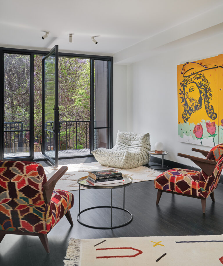 The new second-story family room/gallery showcases a canvas by Bobby Cruz and Ligne Roset’s signature Togo lounge chair.