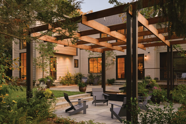 A backyard in Bethesda features a custom mahogany arbor above a bluestone terrace.