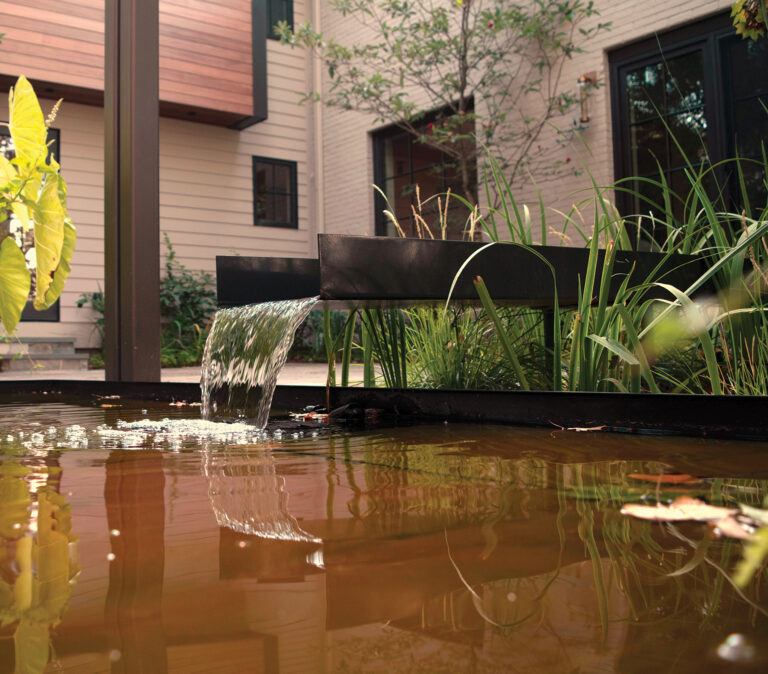A stainless-steel floating fountain is a picturesque addition to the backyard.