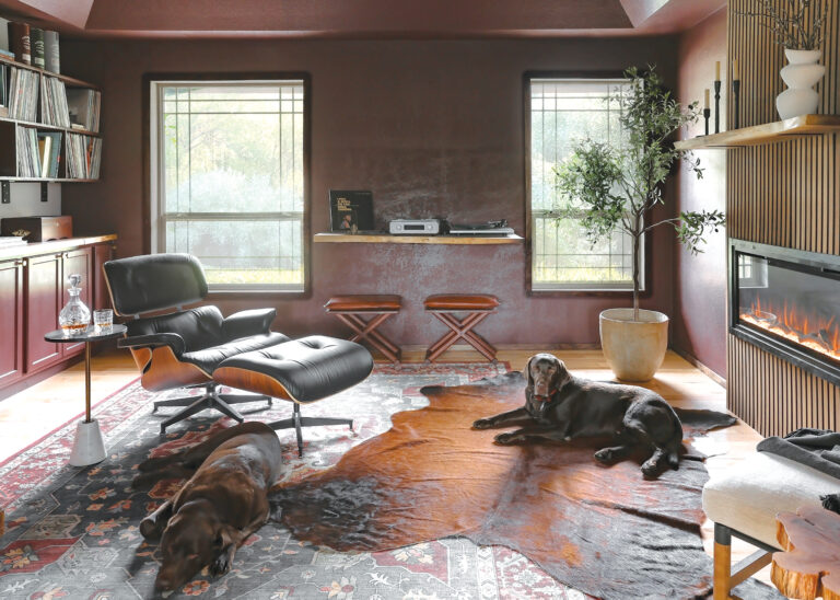 A rich burgundy treatment on walls and ceiling contributes to the moody vibe in a layered listening room. Styling: Genny Moller.