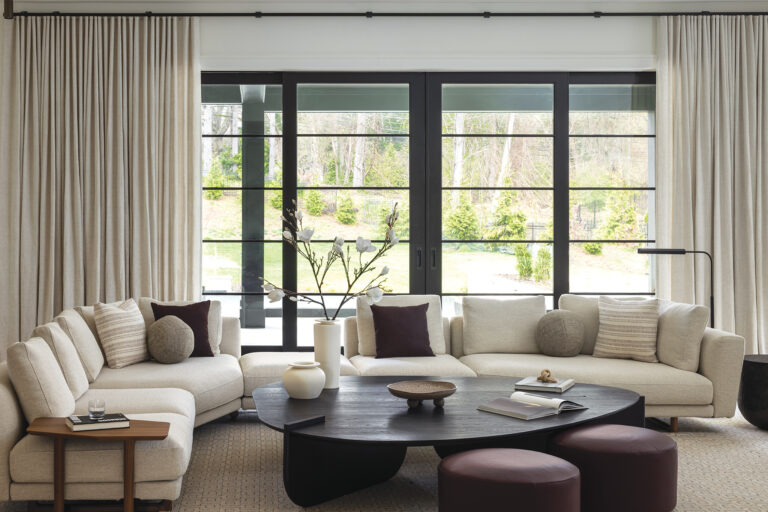 Porada furnishings beckon in a family room where the view is framed by Holly Hunt draperies fabricated by Rockville Interiors.