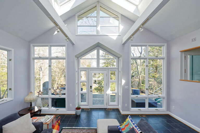 An enclosed porch provides indoor-outdoor flow and plenty of natural light.