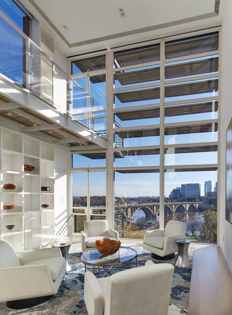 A four-story, steel-and-glass addition to a Georgetown townhouse opens the double-height living room to expansive views of the Potomac River.