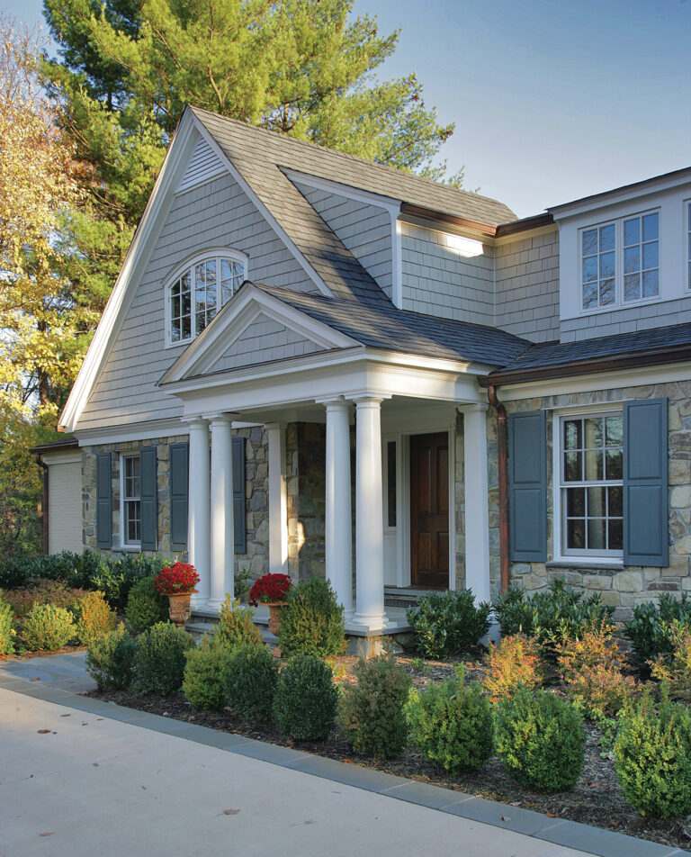 A Shingle-style home in Potomac Falls, Maryland, was reimagined with a front portico, landscaping and street presence.