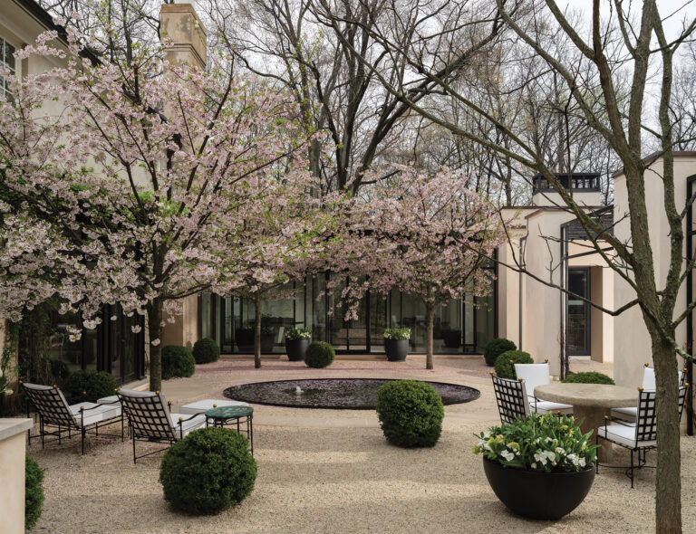 For a modern Potomac project, Richardson and his team designed a courtyard with a stainless-steel reflecting pool. Yoshino Cherry trees emerge from the chipped-gravel expanse.