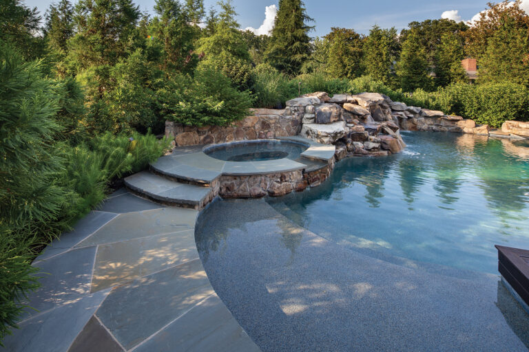 Bluestone slabs were cut to follow the curved edge of a pool and spa in Vienna without the use of traditional coping.