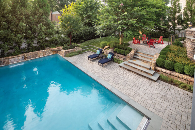 Verdant privacy plantings surround a spacious Great Falls swimming pool.