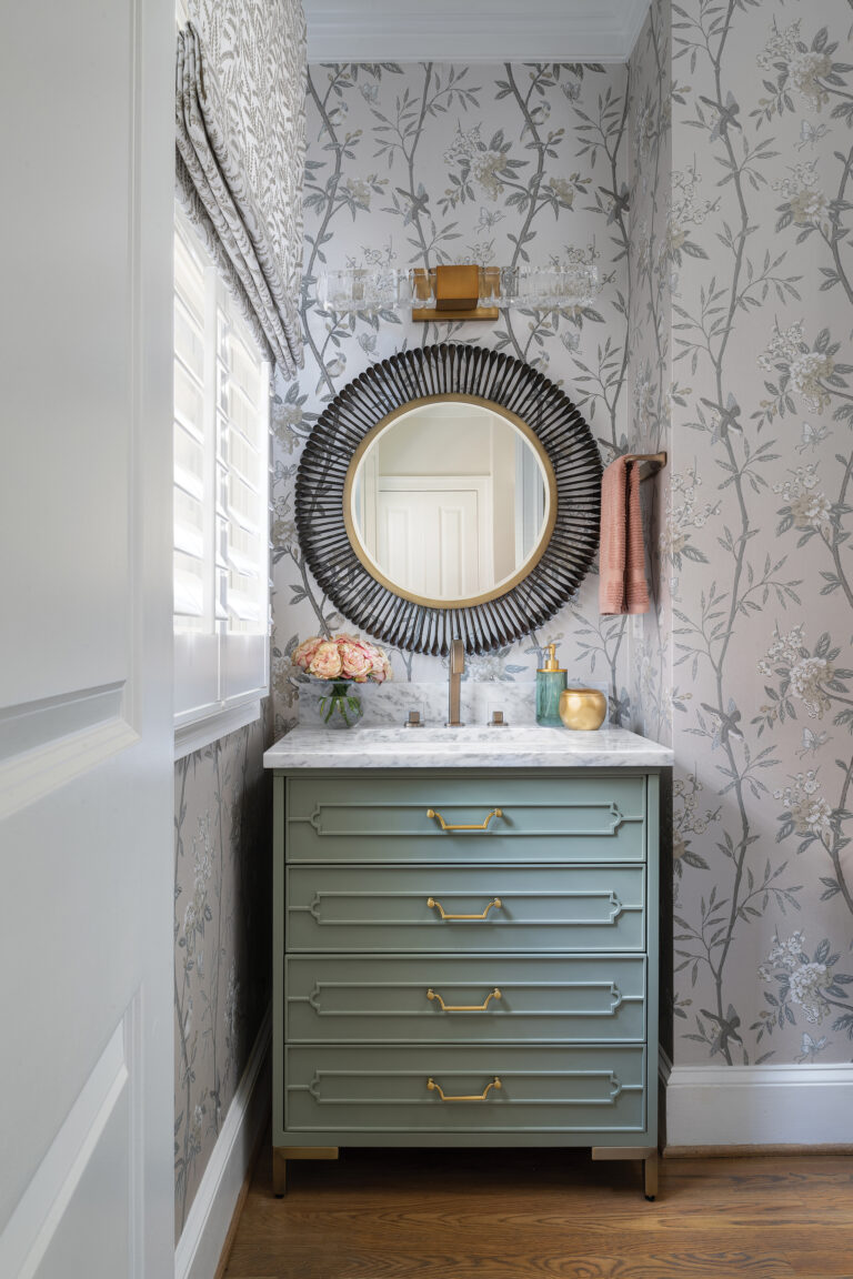 A chic powder room showcases Kravet wall covering and a Vanguard vanity.
