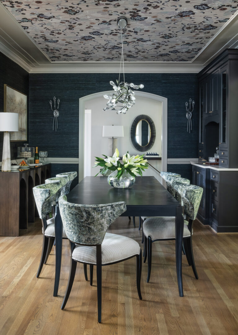 Arte wall and ceiling coverings elevate a Bethesda dining room; a Schonbek chandelier sparkles above a Century table.