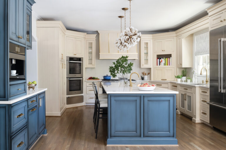 In a Bethesda kitchen, two-tone custom cabinetry is paired with quartz countertops and backsplash. 