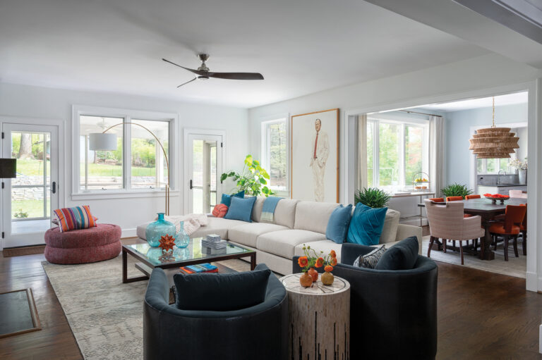 For a family room makeover, Houck specified comfy, stylish furnishings upholstered in hardy fabrics; a portrait of the wife’s father adds meaning.