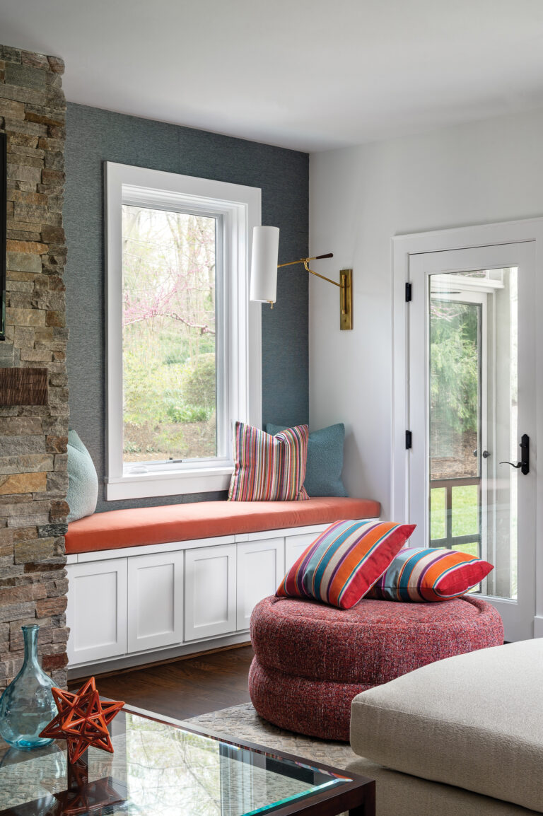 Alcoves flanking the family room’s stone fireplace are now cozy reading nooks equipped with custom bench seats.