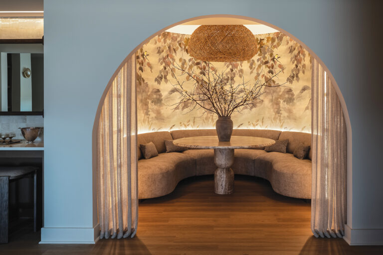 A empty, octagonal-shaped space without a purpose became a curved bar retreat that hosts events and parties; a custom mural and edge lighting set the scene.