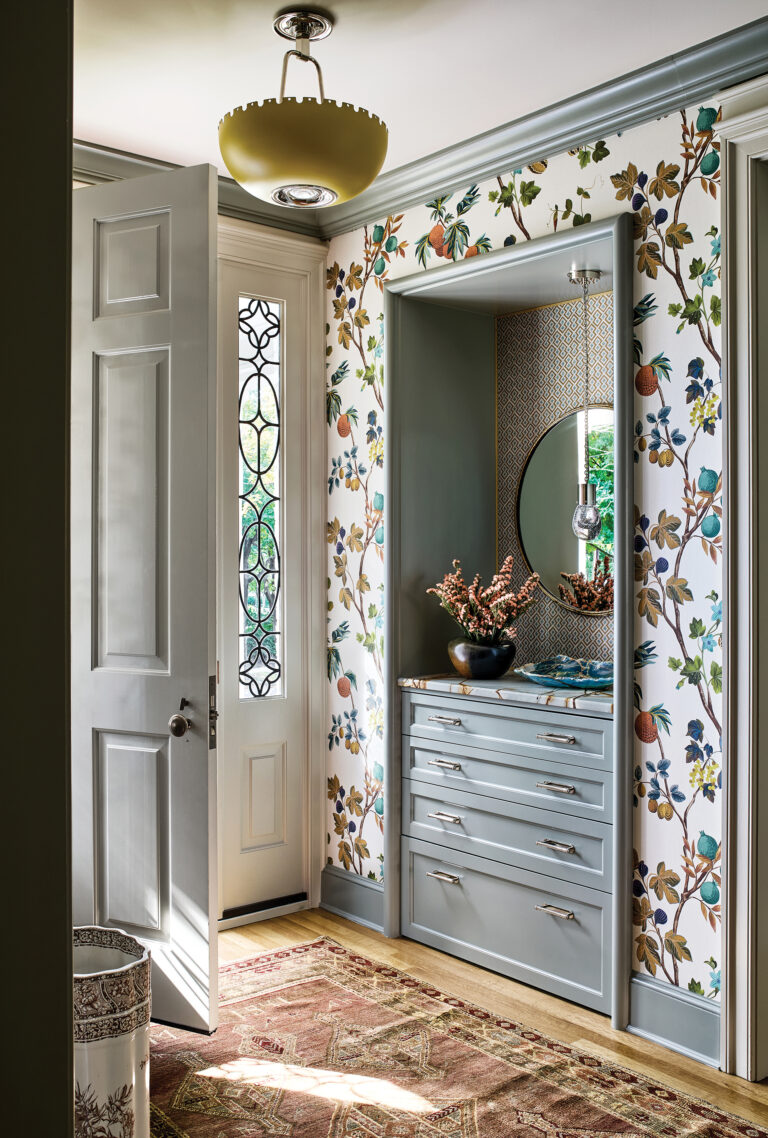 A Chevy Chase foyer got a facelift via a restored front door with leaded glass sidelites and custom built-ins.