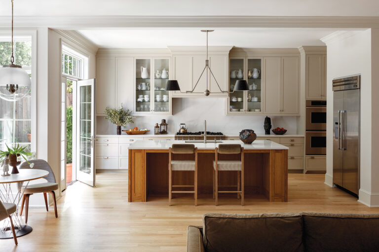 Painted cabinets and a white oak island revived a Bethesda kitchen; French doors enlarged the opening to the rear terrace.