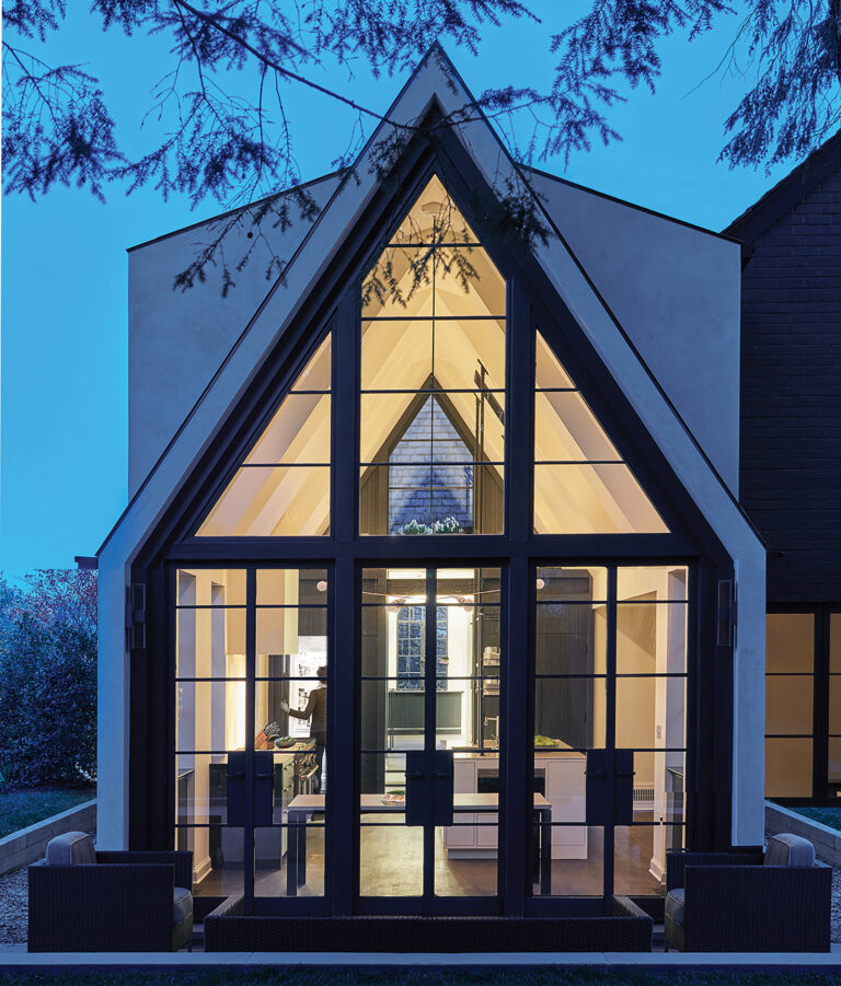 A soaring modern addition respects this home’s original Tudor pitch and materialism.