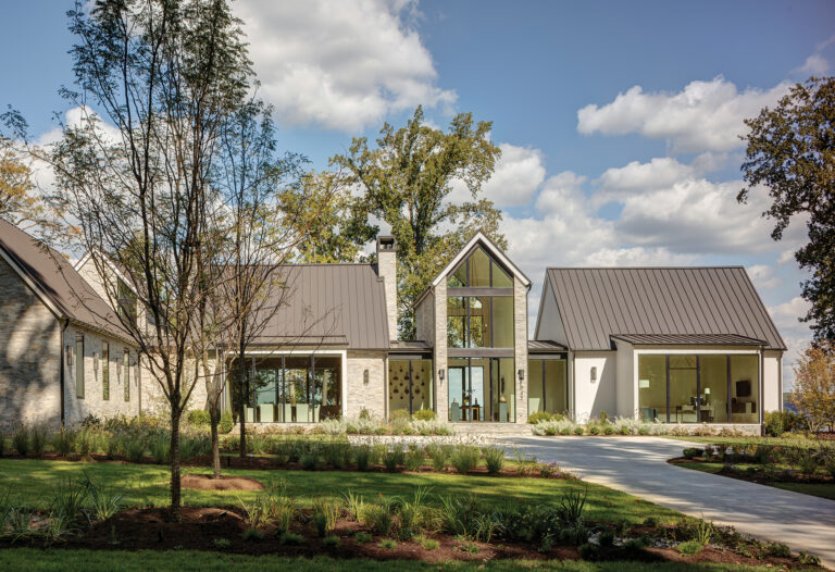 A modern Annapolis home conjures a clean, warm aesthetic with glass, stone, a standing-seam metal roof and vertical nickel-gap siding.