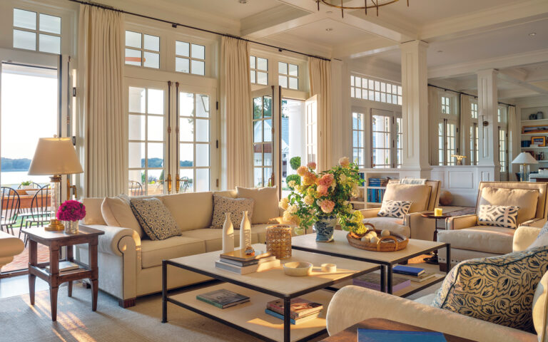 A serene living room overlooking the water establishes a calming foundation through neutral hues; custom millwork adds character.